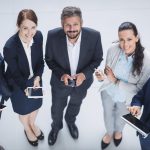 businesspeople-using-mobile-phone-digital-tablet-scaled