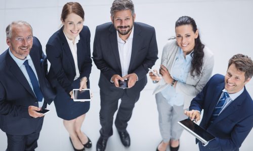 businesspeople-using-mobile-phone-digital-tablet-scaled