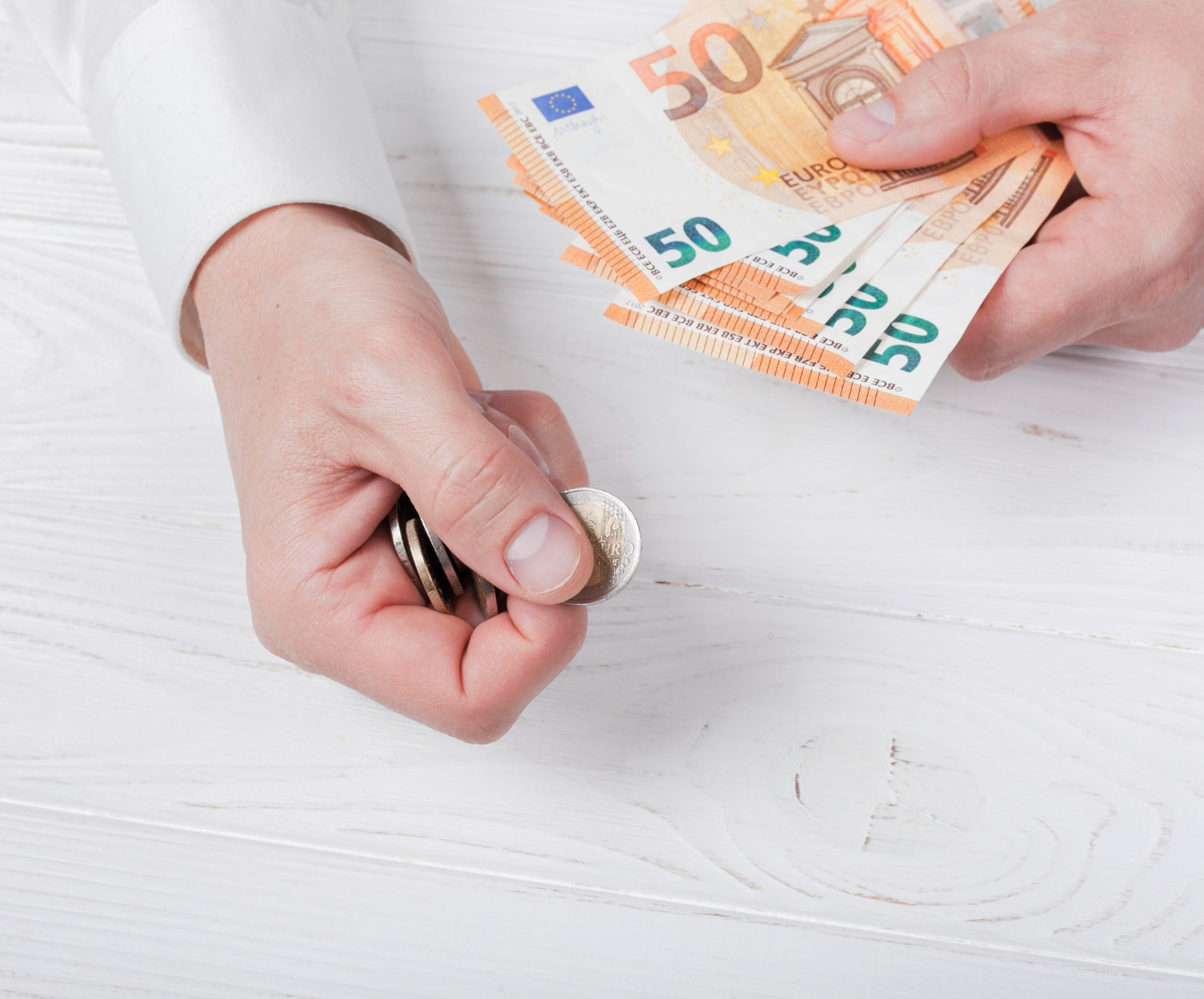Man holding bank-notes and coins