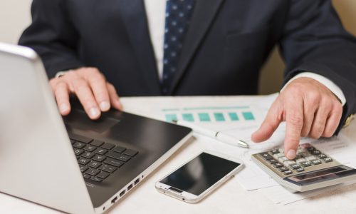 Businessman using calculator
